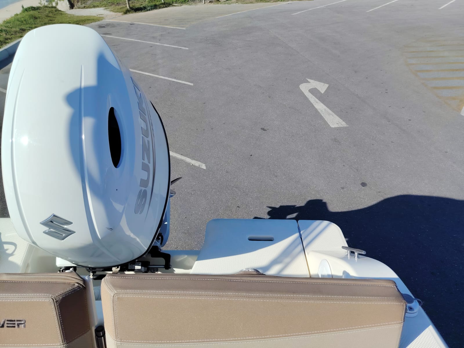 Suzuki outboard motor on a boat in a parking lot