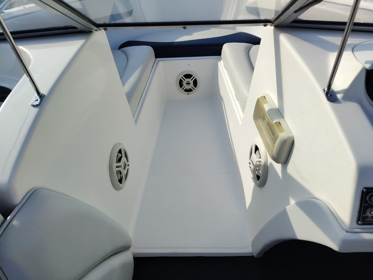 Blue and white Kestrel 575 boat with a Yamaha 150HP four-stroke outboard and trailer.