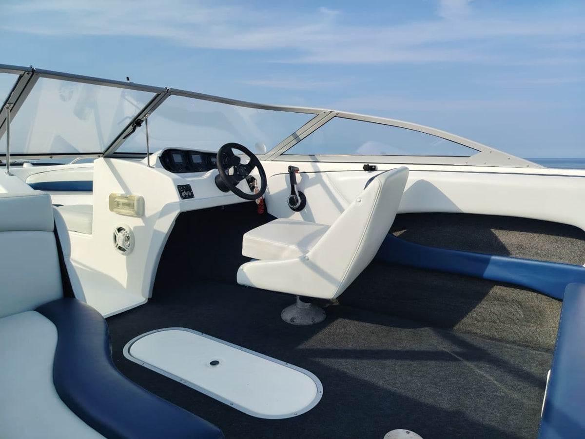 Blue and white Kestrel 575 boat with a Yamaha 150HP four-stroke outboard and trailer.
