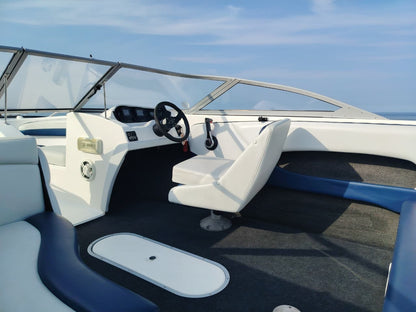 Blue and white Kestrel 575 boat with a Yamaha 150HP four-stroke outboard and trailer.