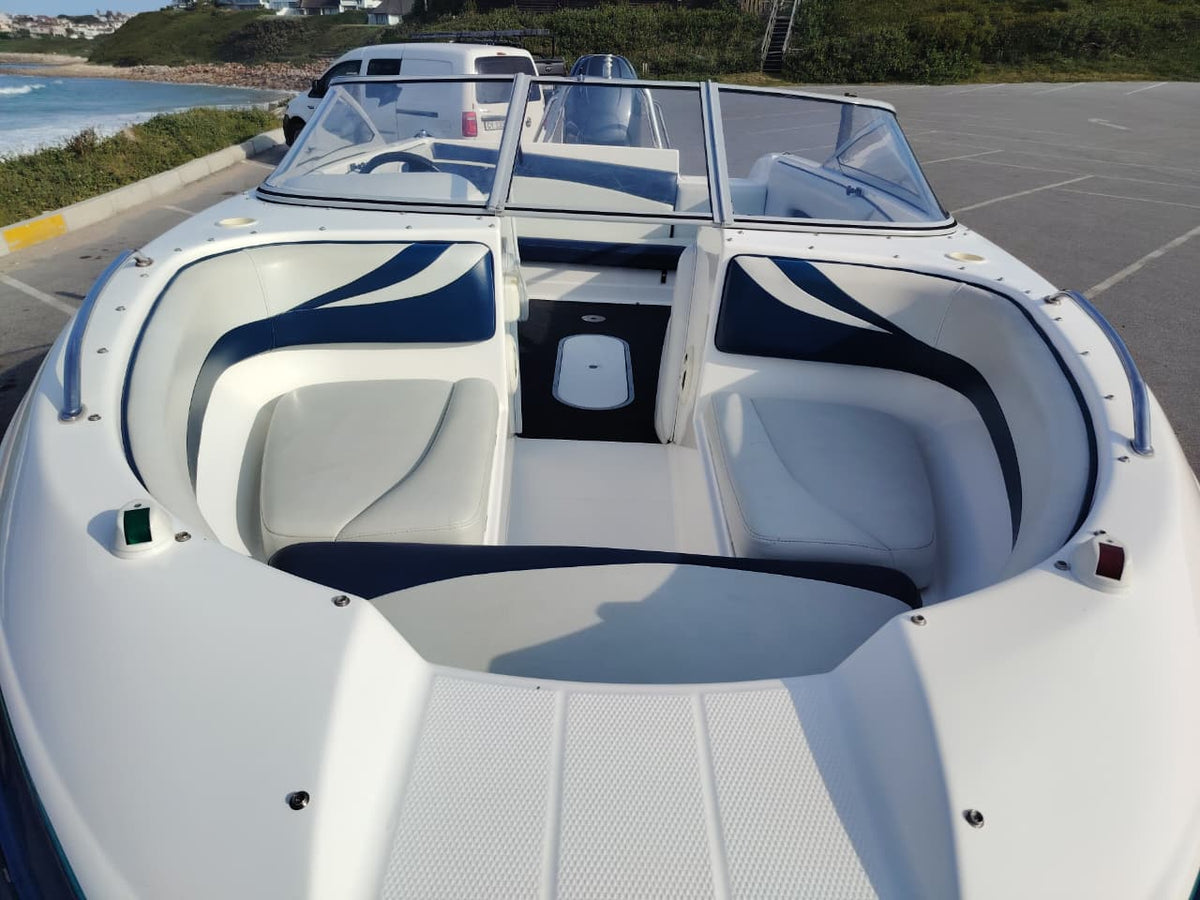Blue and white Kestrel 575 boat with a Yamaha 150HP four-stroke outboard and trailer.